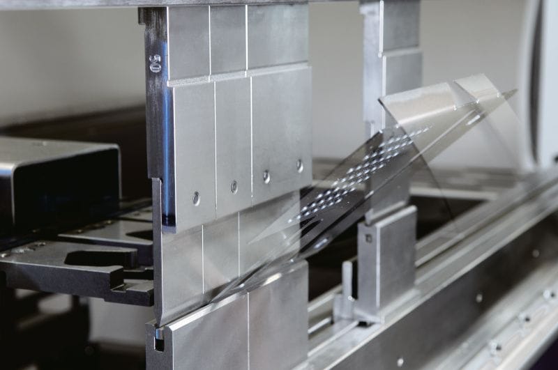 Press brake punch and die closing on sheet steel, forming a crisp flange